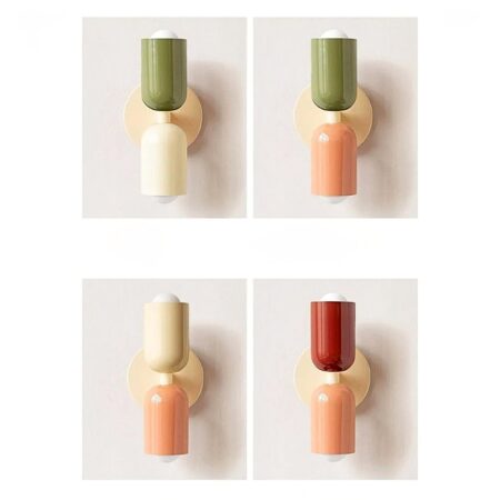 man sieht an einer hellgrauen Wand 4 Wandleuchten im skandinavischen Stil mit verschiedenen Farben weiß grün rosa und rot